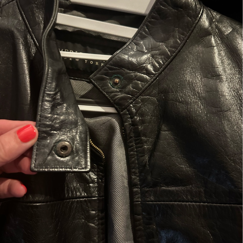 Black leather collarless jacket. Zipper with concealed closer.Beautiful leather.